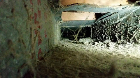 Air duct before cleaning, full of dust and debris