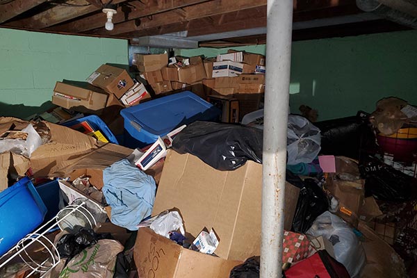 Before image of basement hoarding cleanup
